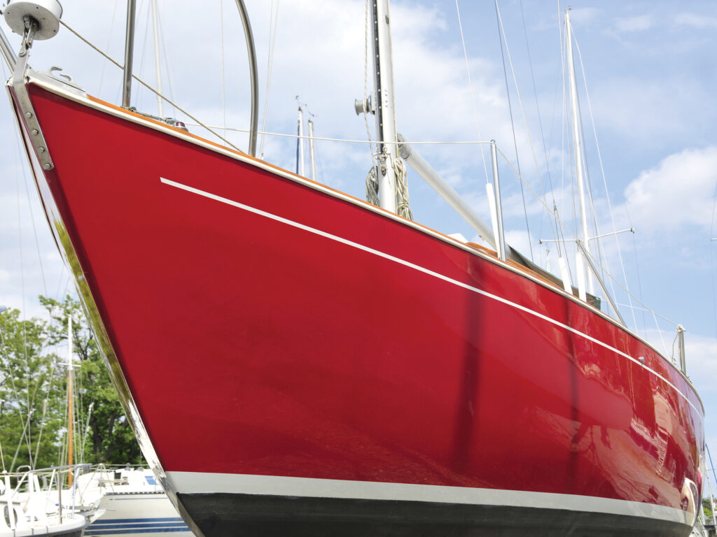 Man painting his sailboat