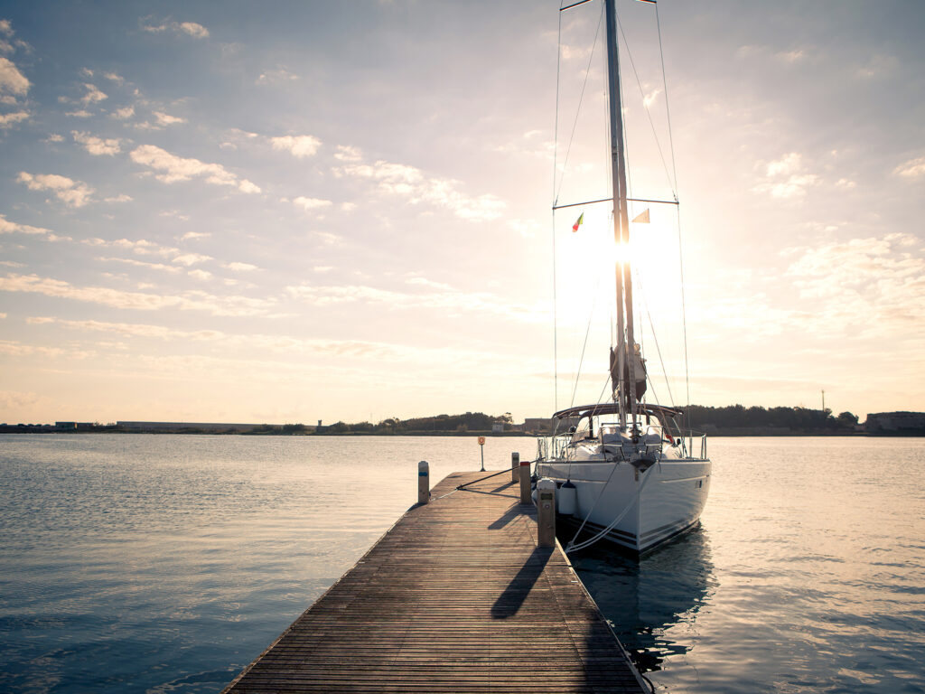 Sailing yacht moored to the pier at sunset, a weekend for lovers of the sea