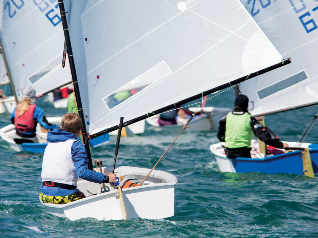 group of children on sailing boats