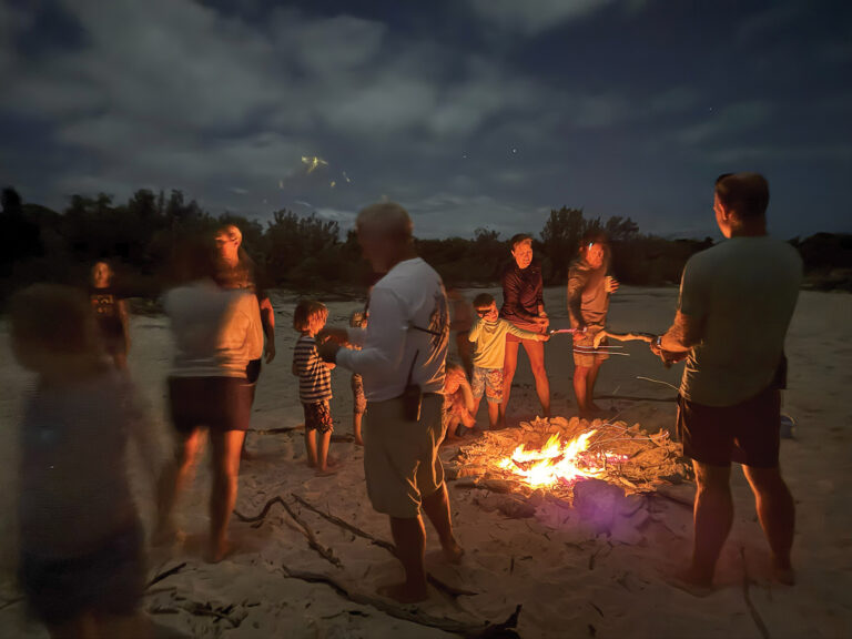 People around a bonfire on the beach