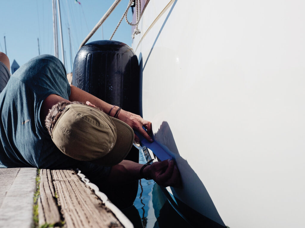 Chris Neely prepping for repair of a sailboat