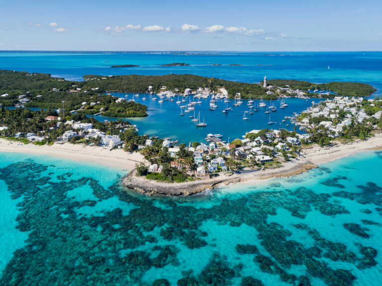 Aerial view of the harbour, beach and lighthouse in Hope Town on Elbow Cay off the island of Abaco, Bahamas.