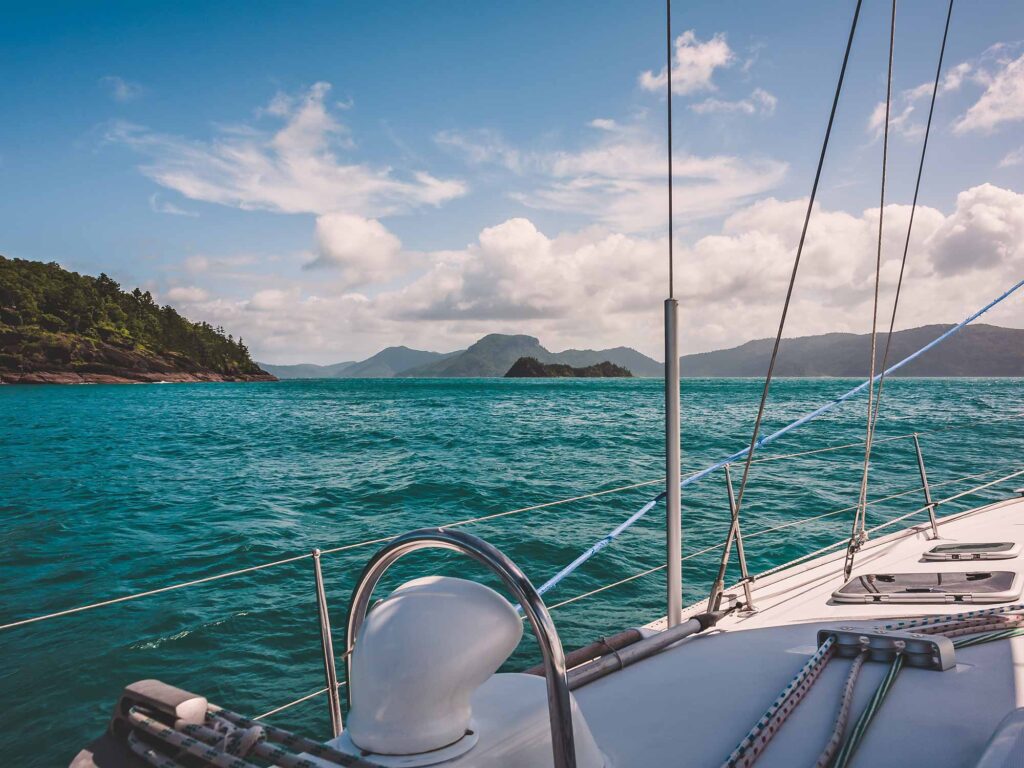 Sailboat sailing on a warm beautiful day in the Whitsunday Islands on the Great Barrier Reef in Australia.