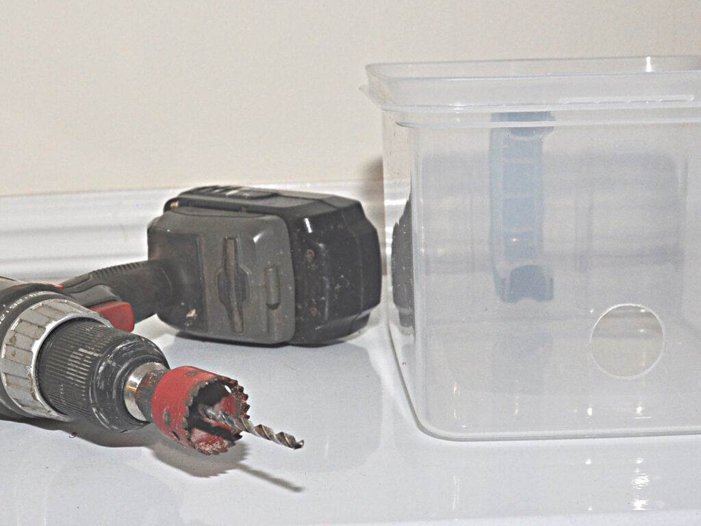 drill and container for drain box