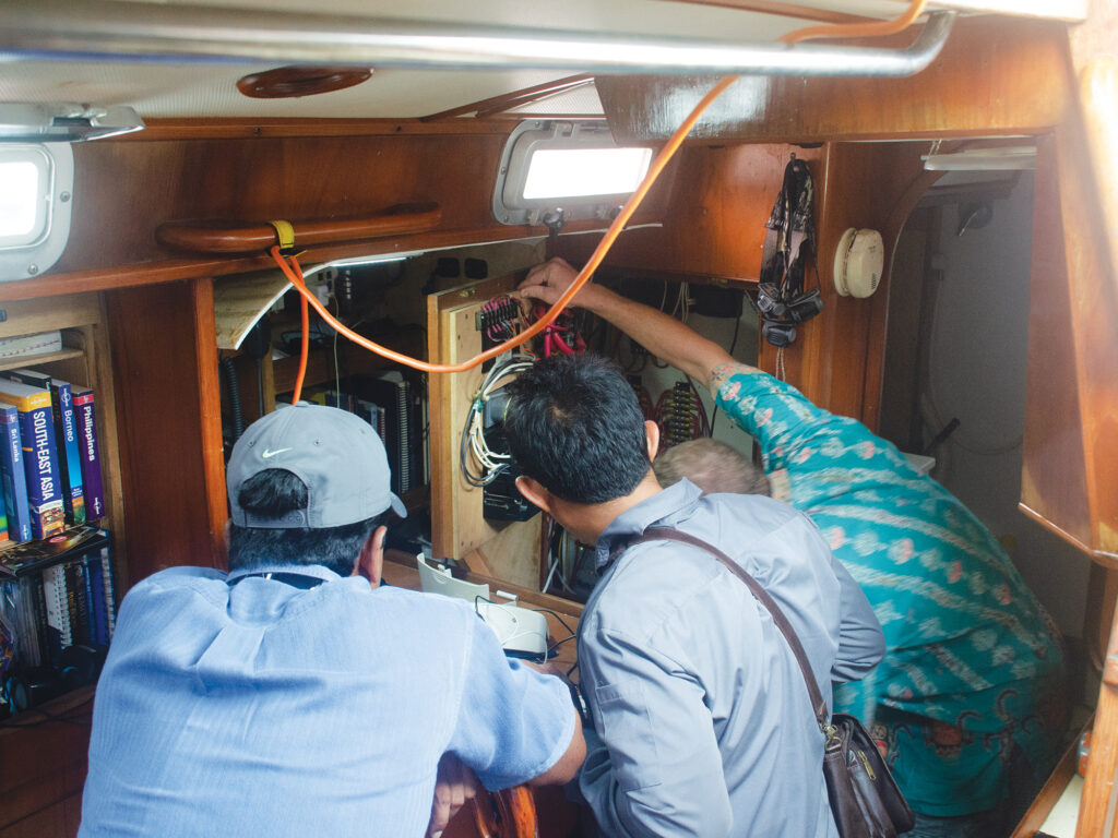 People inspecting a multistage battery charger