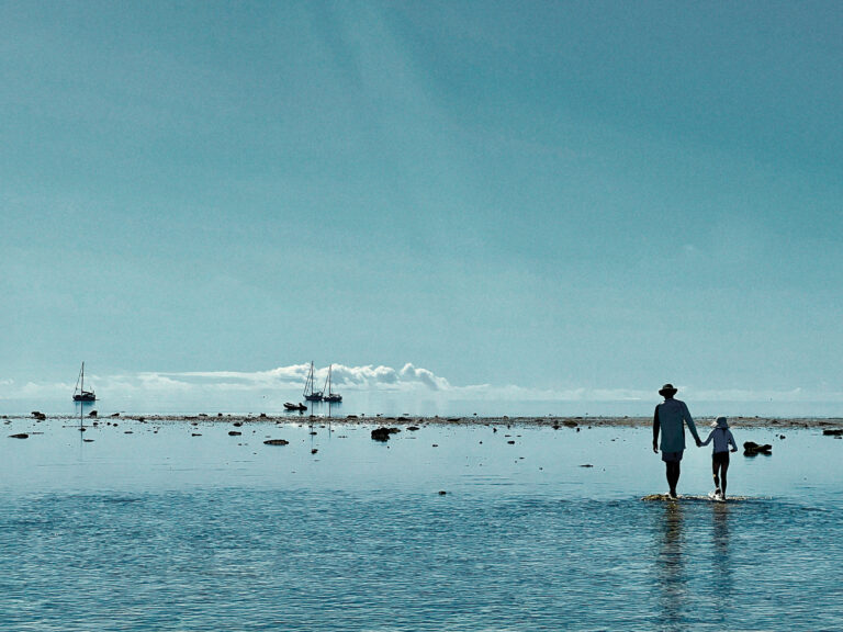 Father and daughter walking on the beach