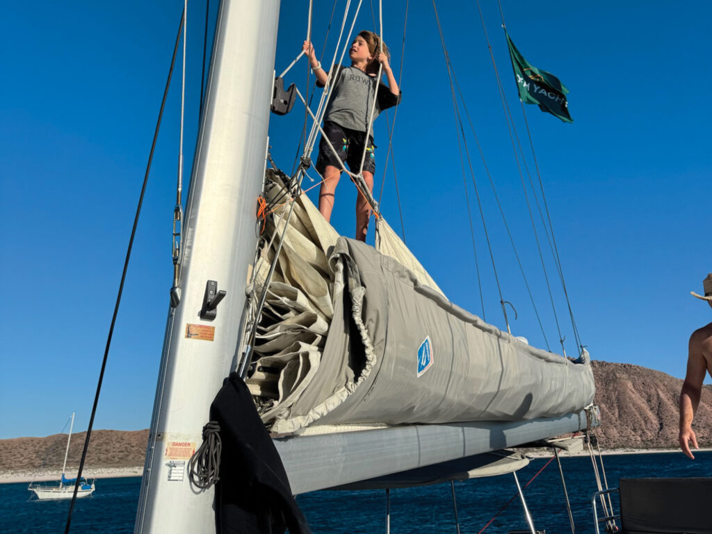 Child hoisting the mainsail