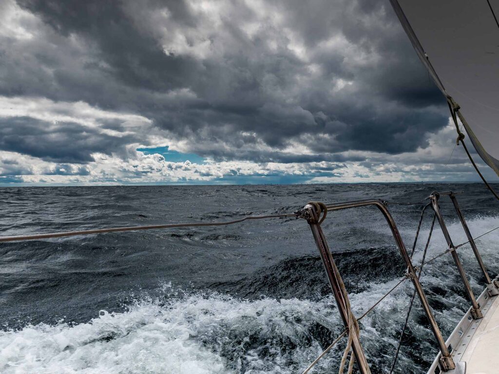 Sailing Yacht on Rough Sea Under Stormy Sky, Ocean Adventure Perspective. High quality photo