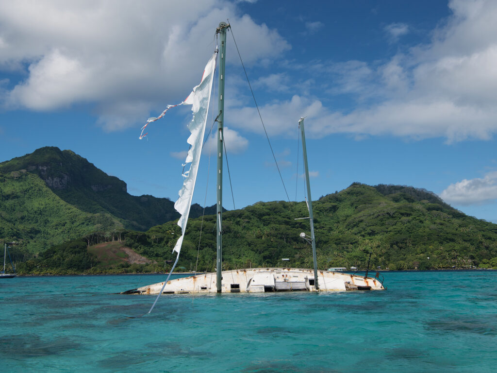 Half-sunken sailboat offshore