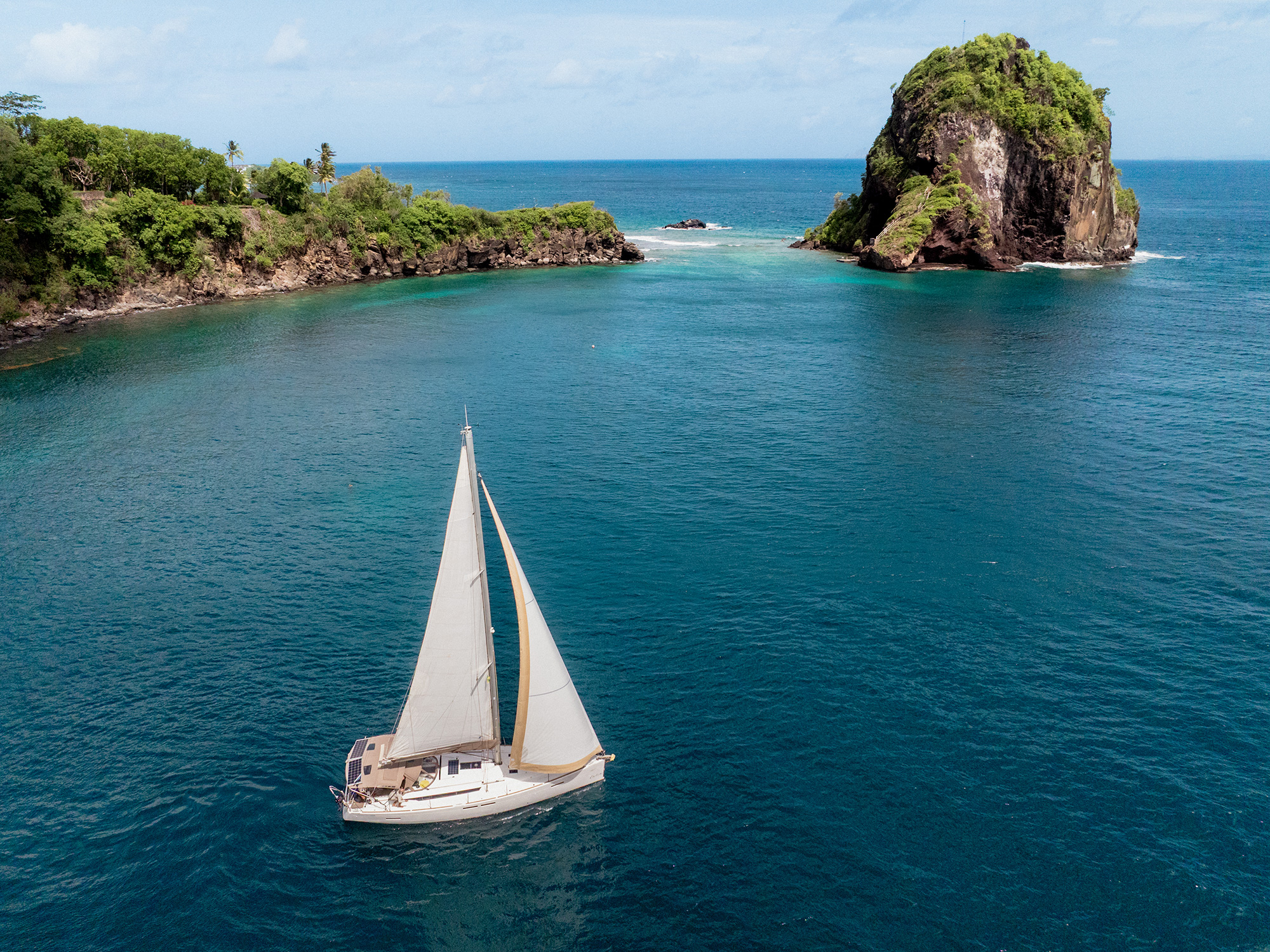 Drone view of a sailboat in a lagoon