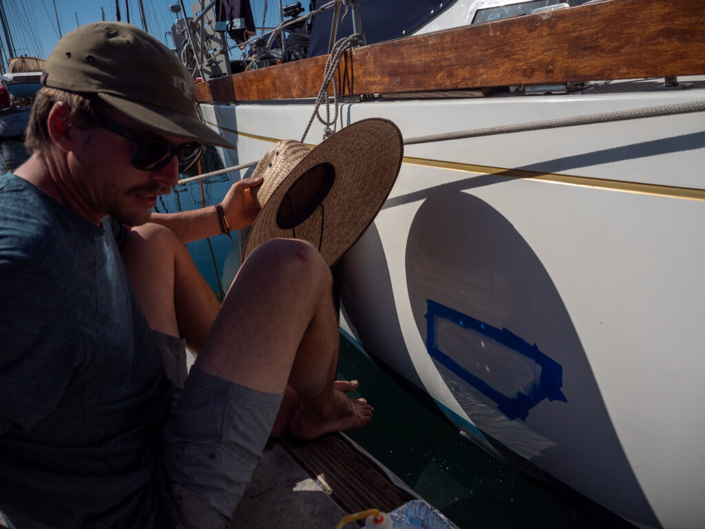 Painting the hull of a sailboat