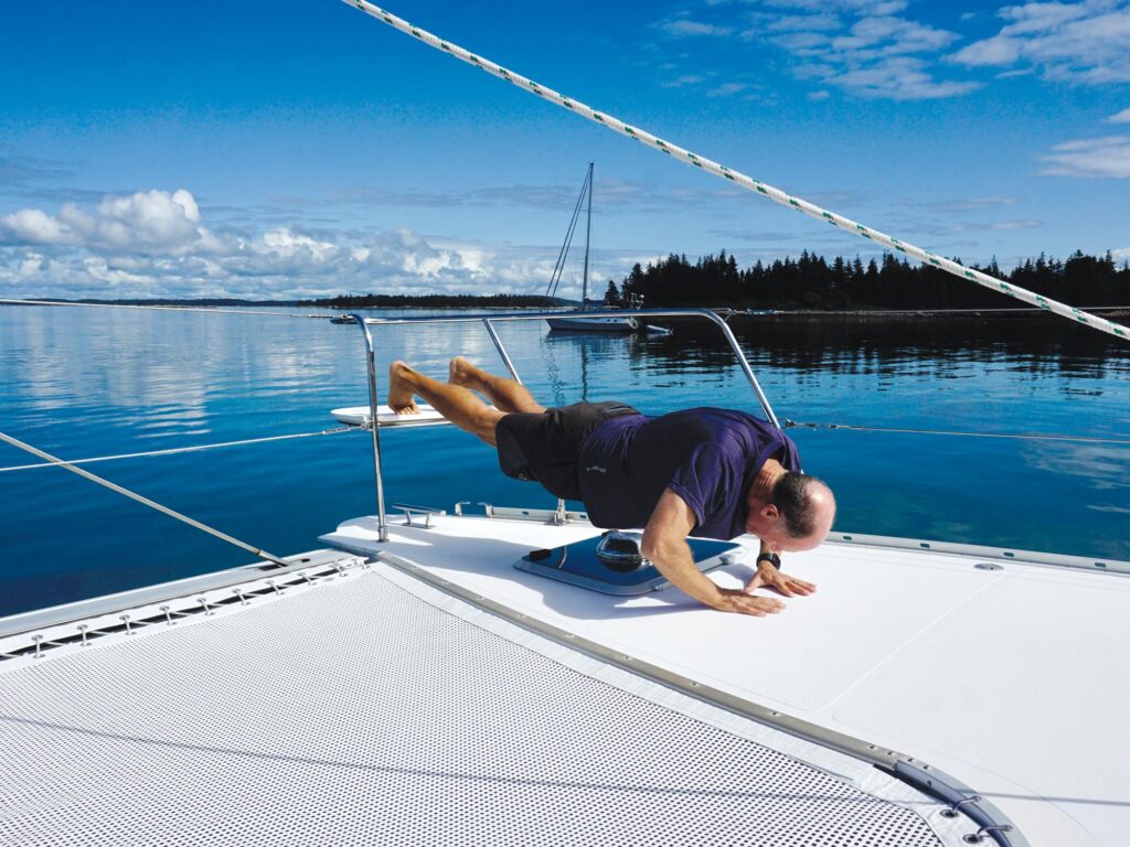 Man exercising on a sailboat