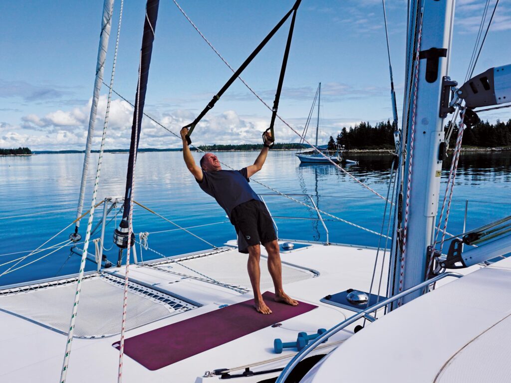 Man exercising on a sailboat
